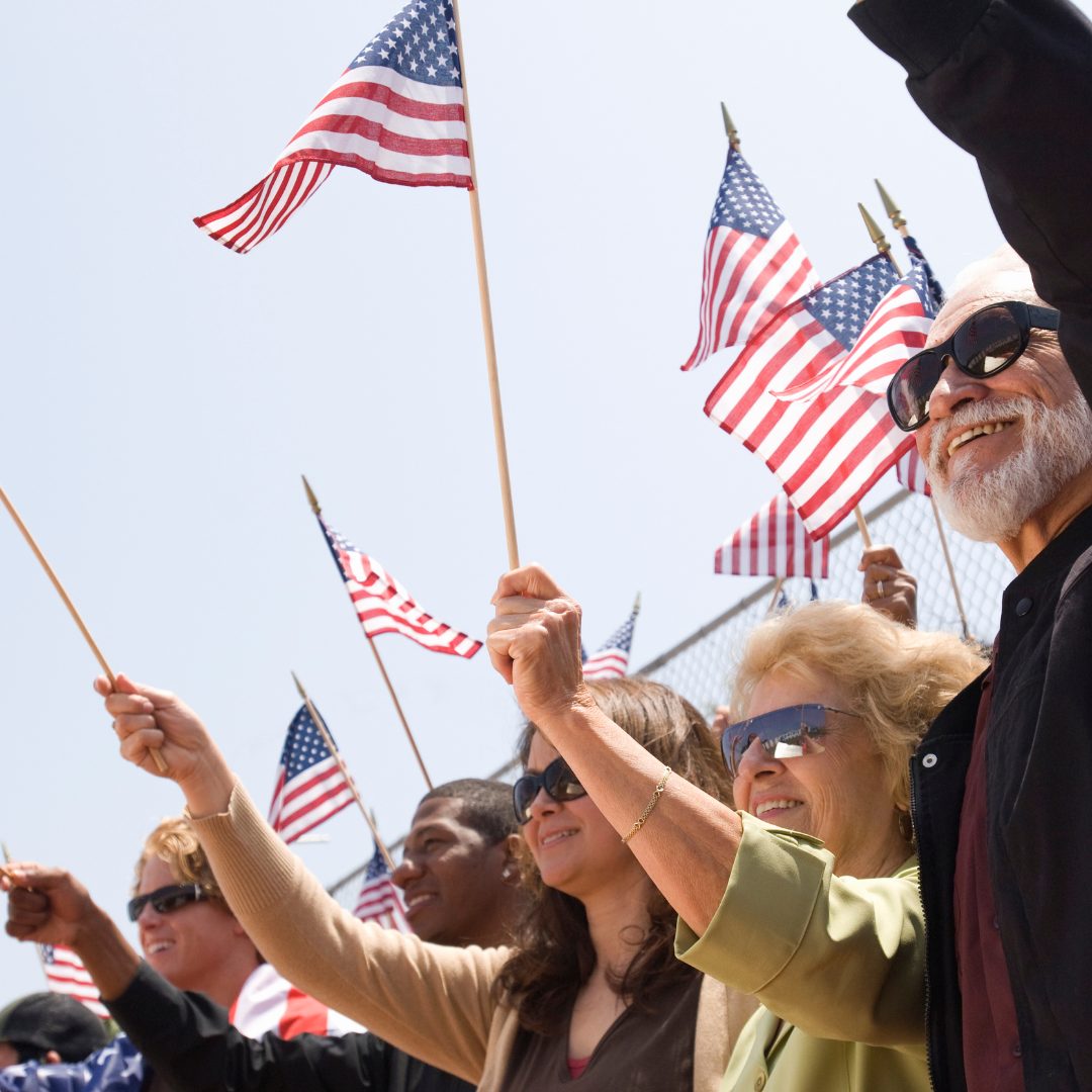 Family and community members waving American flags