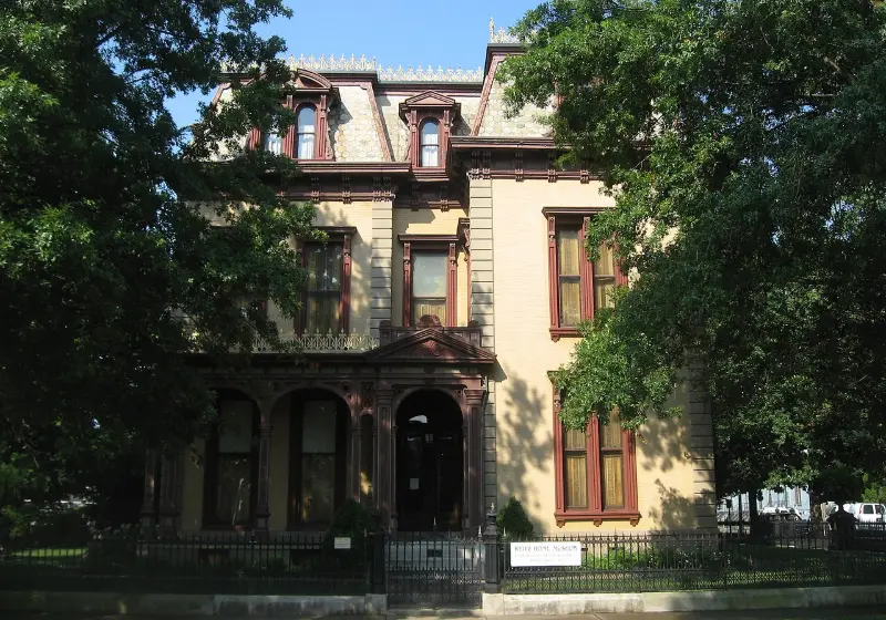 The Reitz Home, a three-story brick mansion behind trees